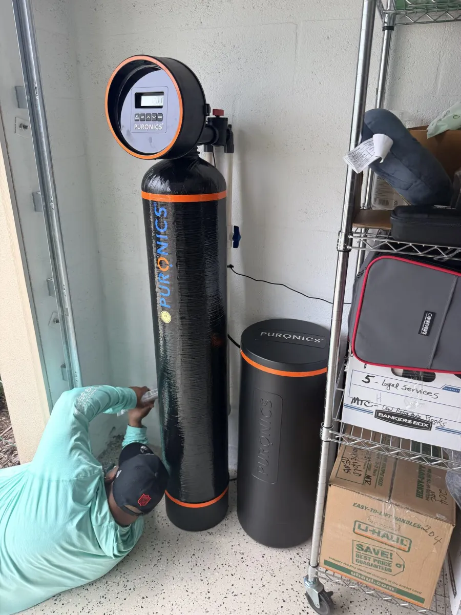 Hydrology technician servicing a water softener